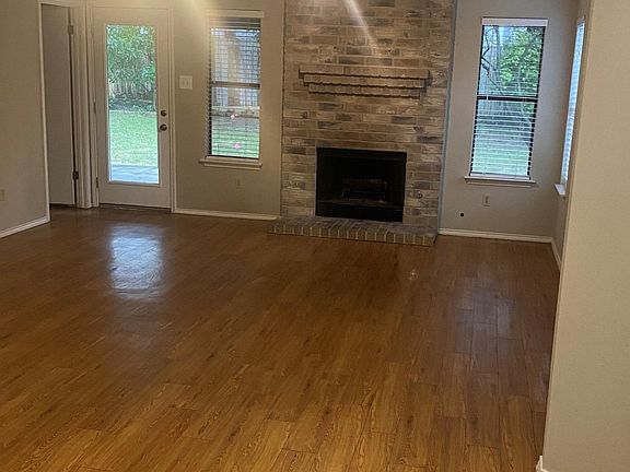 Gorgeous hardwood-like vinyl flooring and gas fireplace in your living room. Easy access thru the French door to your covered patio overlooking the mature trees in your fenced backyard.