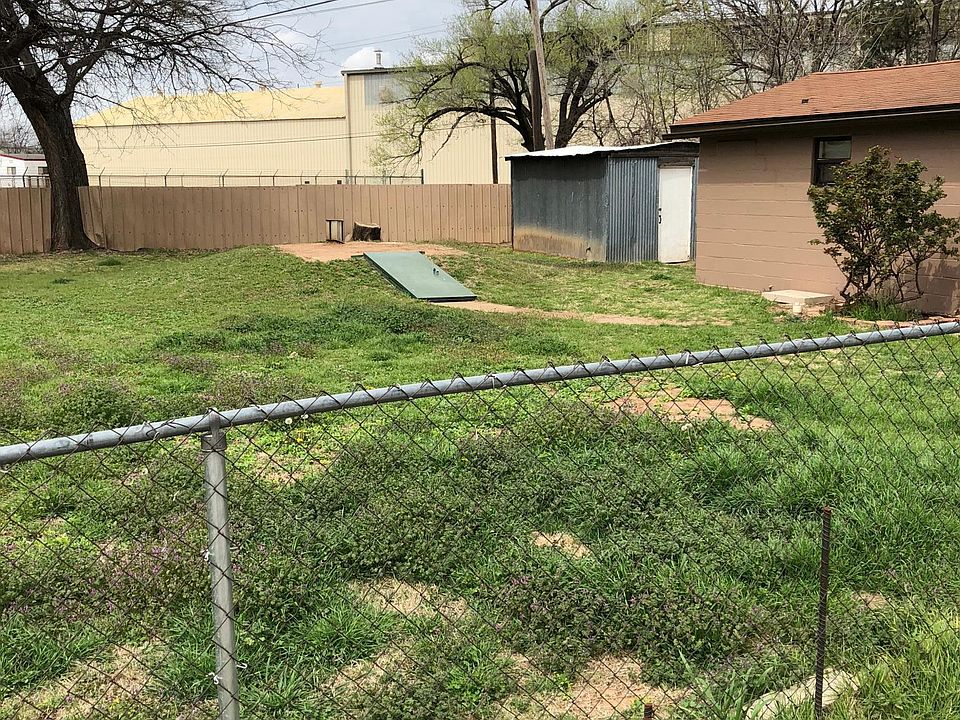 Yard with storage and storm shelter.