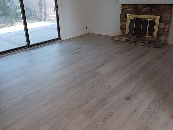 Living Room with Laminate Flooring and Fireplace.