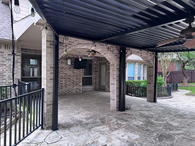 Large covered patio with pergola and built in grill.