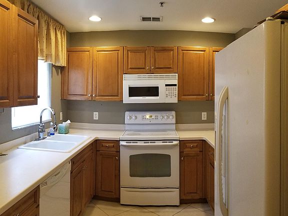 Kitchen with wood cabinets & solid surface countertops
