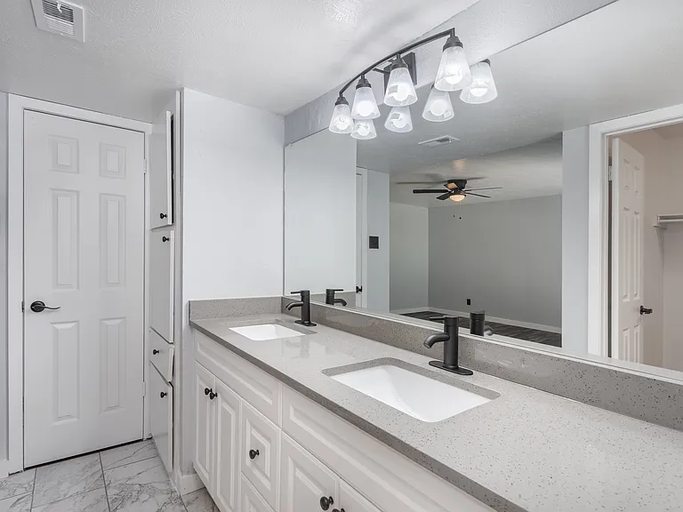 Double-sink vanity with ample storage and bright lighting
