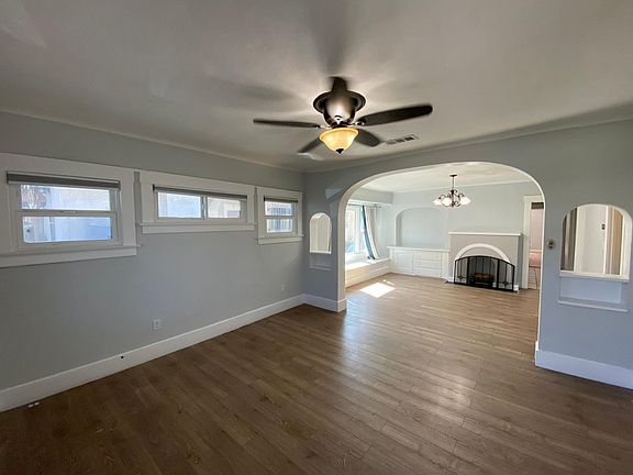 Living Room leading to formal Dining Room with Fire Place