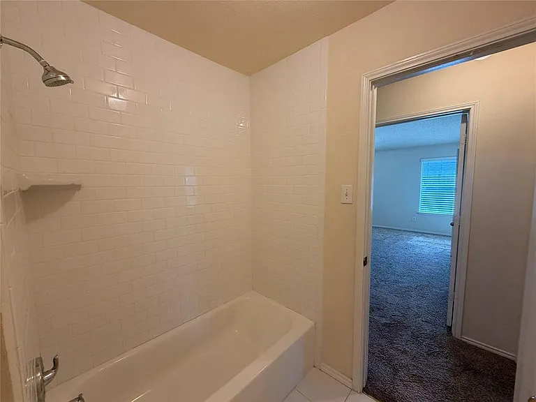 DOORS TO HALL BATH IN EACH HALLWAY. SOAKING TUB AND SHOWER HEAD.
