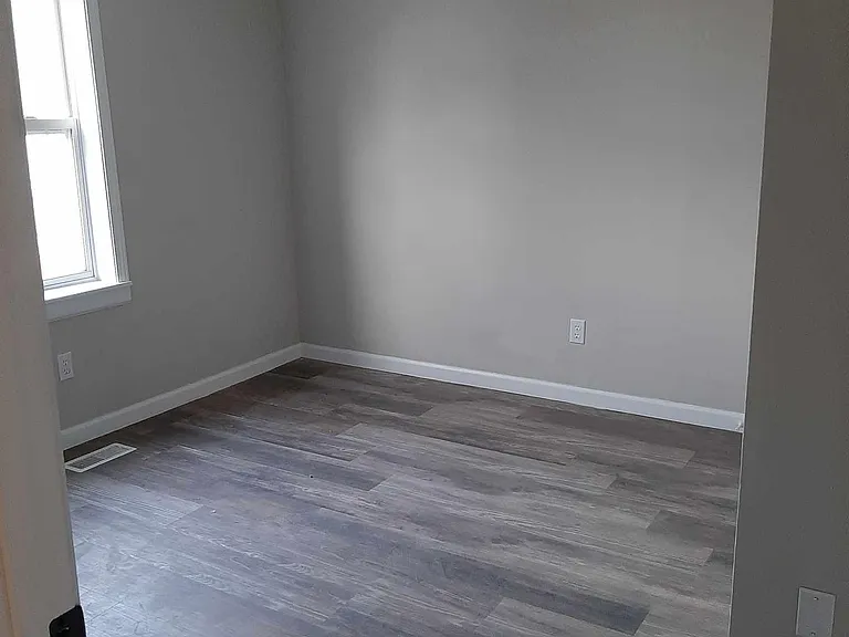 Bedroom with ceiling fan and closet with light.