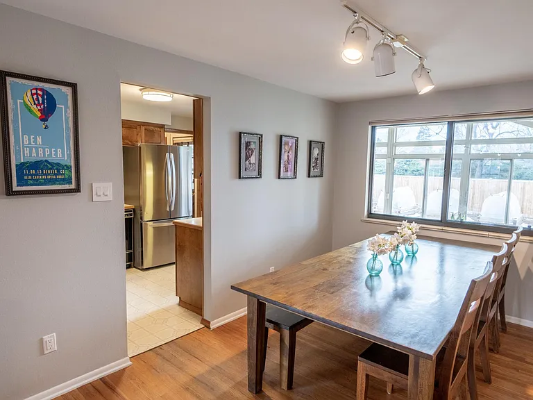 View from the north-east of the dining room towards the kitchen, sun room, and back yard.