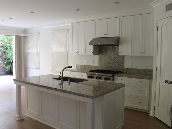 Professional gas range and vent, corner pantry and sliding glass door which opens completely to patio.