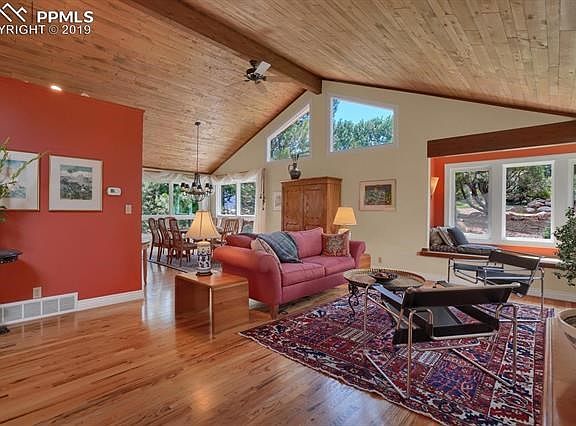 Lofted wood ceilings complete with ceiling fan adorn the formal living and dining rooms.