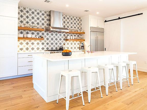 There is a huge open kitchen for entertaining or making a lovely meal from home. Counter seating for five, and a fully equipped kitchen with adjoining butlers pantry with tons of storage, a wine fridge, wet bar, and washer/dryer.