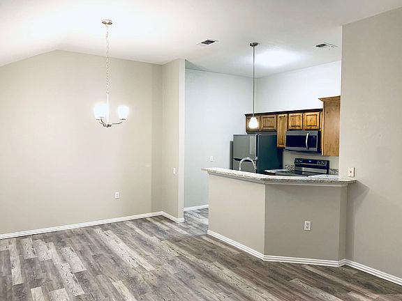 Looking from the spacious living room into the dining room/kitchen area