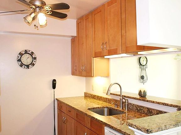 Kitchen with granite countertops and pass-thru into living room