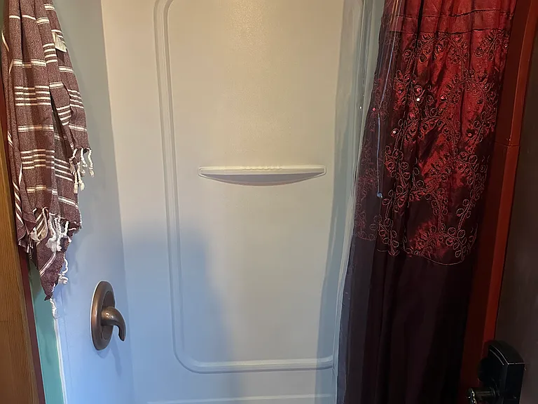 The tiny shower has a low-flow shower head and basic toiletries are provided. Please note it's a 4-gallon water tank so showers are limited to 4-minutes. The pause button helps, but it's a quick shower!