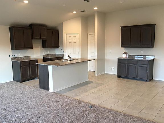 Huge kitchen with granite countertops and grey cabinets