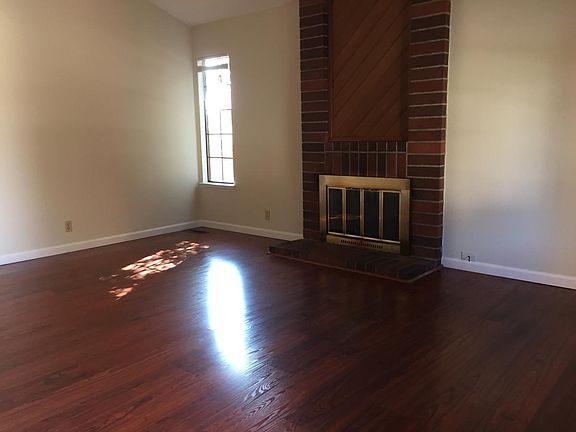 Living room with vaulted ceiling and fireplace