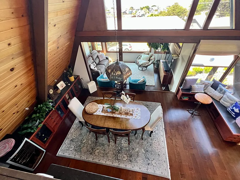 Looking down over dining and living areas from loft