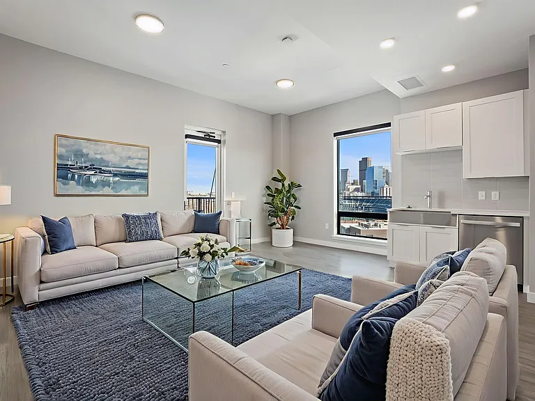Enjoy the convenience of a modern living room with large windows that fill the space with natural light.