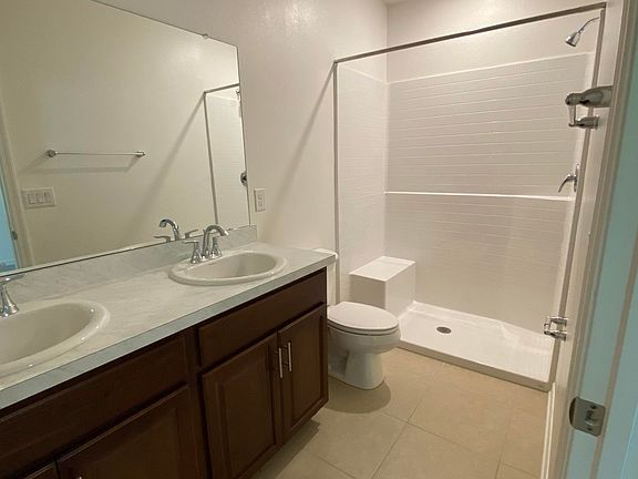 Master bathroom with double vanity and walk-in shower.