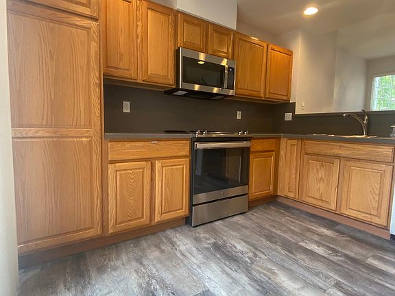 Updated kitchen with new appliances and plank flooring.