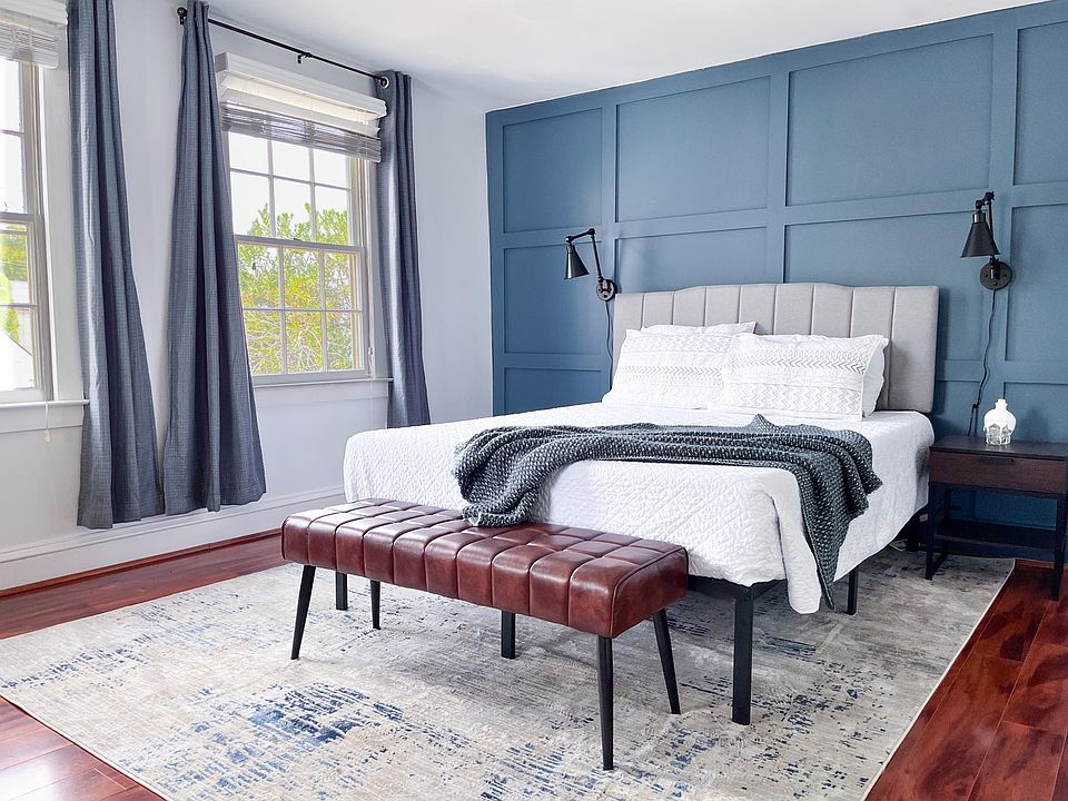 Spacious primary bedroom with full furnishings and natural light.