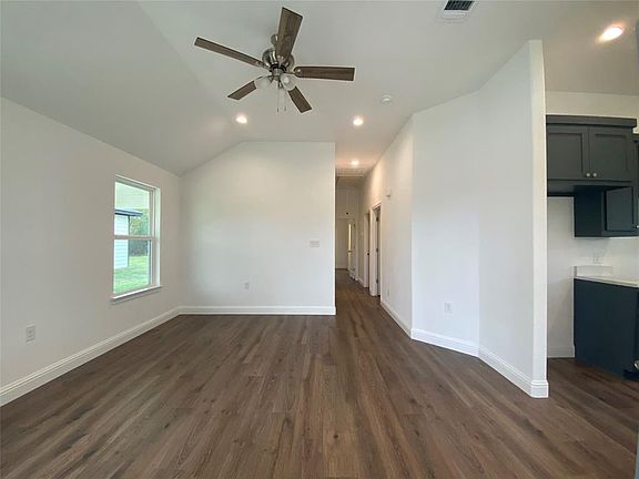 Living room with recessed lighting, dark wood-style flooring, and a ceiling fan
