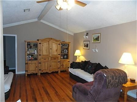Large living room with wood floors and high ceilings