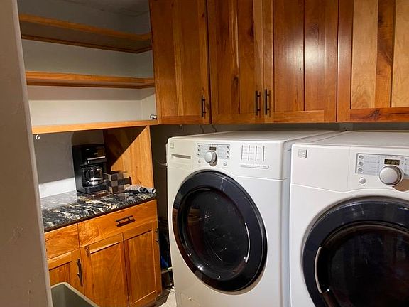 Utility room with full size washer dryer and coffee bar