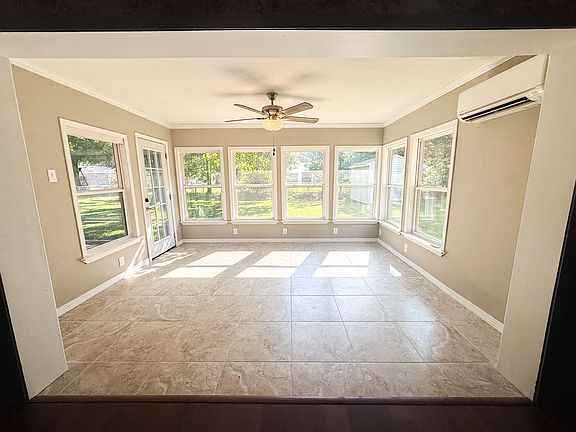 Sunroom
Flooded with natural light through a wall of windows, tile flooring, and ceiling fan. Mini-split system provides year-round comfort.