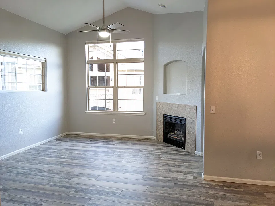 Living area with fireplace, vaulted ceilings and wood floors throughout