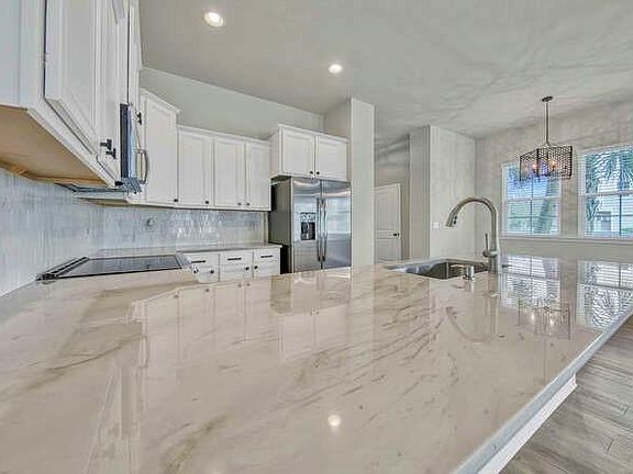 Completely refinished kitchen with new countertops and back splash.
