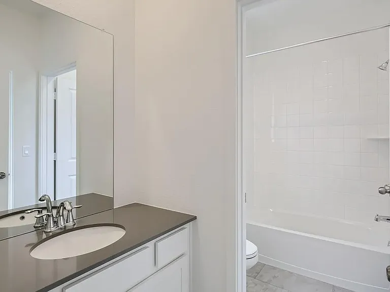 Shared bathroom includes bathtub and shower