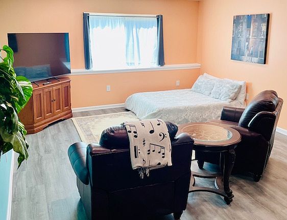 Alternate layout of living room to accommodate another bed.
