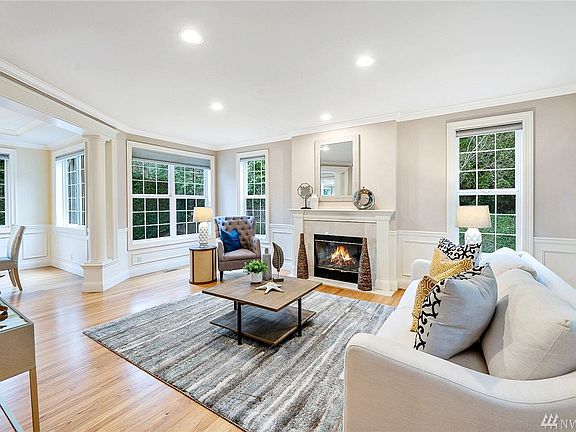 The generously sized formal living room flows into the formal dining room.  Greenery and glass everywhere you look, and yet totally, peacefully, private.