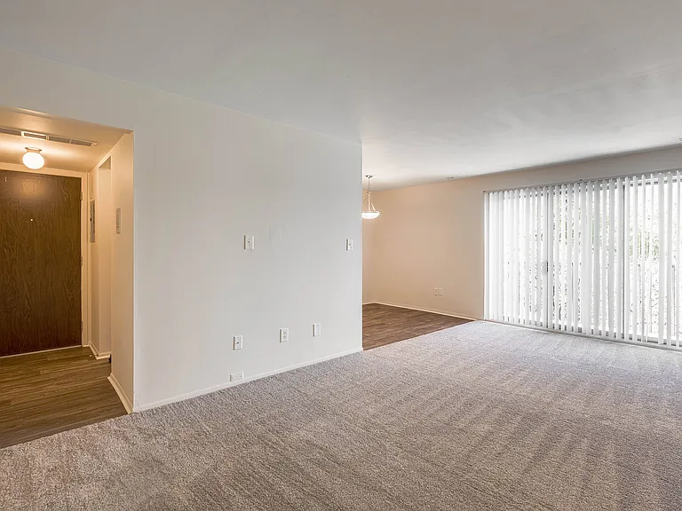 Open and airy entry way and living room at Knottingham Apartments in Clinton Township, M