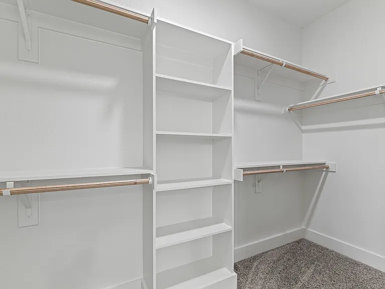 Master suite walk-in closet dimension is approximately 11' x 5'6" with rods on three sides.