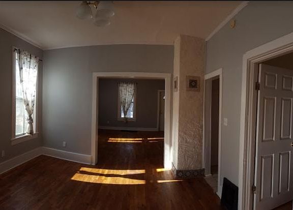 Dining room facing into the living room, hall enters into bathroom area, door enters into 2nd bedroom.