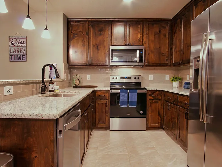 The kitchen offers stainless steel appliances, a breakfast bar with seating for 3. Refrigerator included.