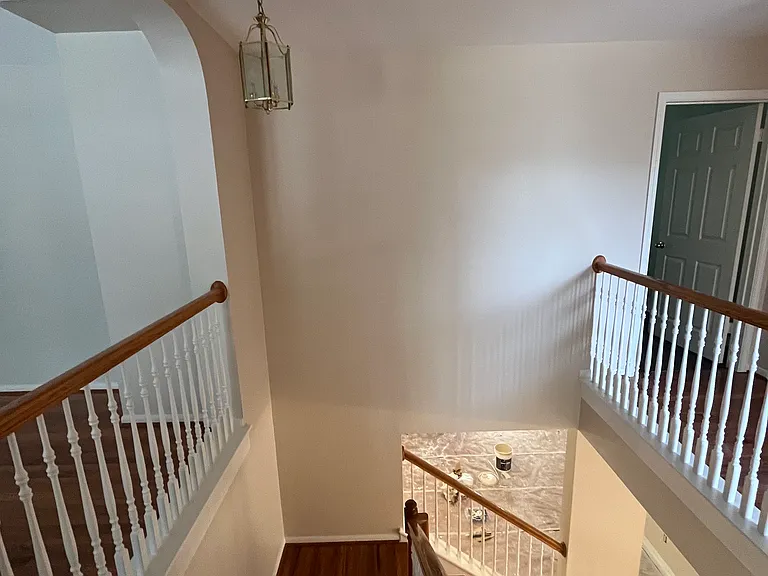 View from upstairs landing - second common area/loft on left. The wood floor and railings are stunning.
