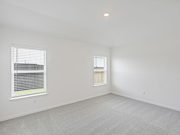 Spacious master bedroom with windows that brighten up the space