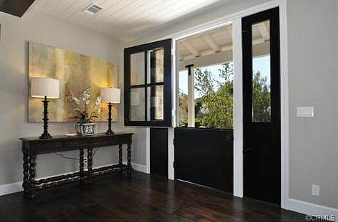 Dutch door opening into high ceiling foyer