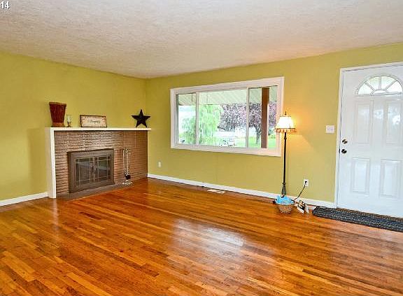 Living Room w/brick fireplace & original HW floors