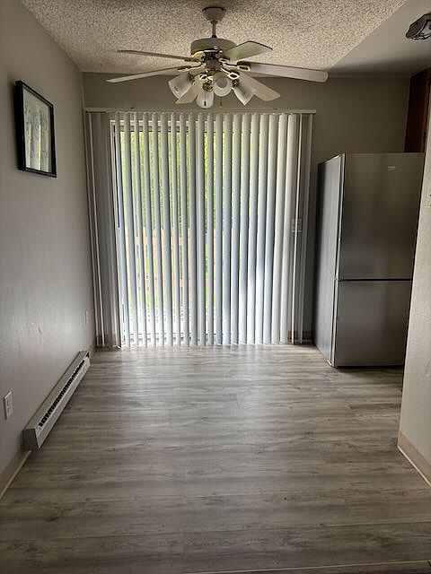 Dining area opens to a new private balcony overlooking a grassy courtyard.