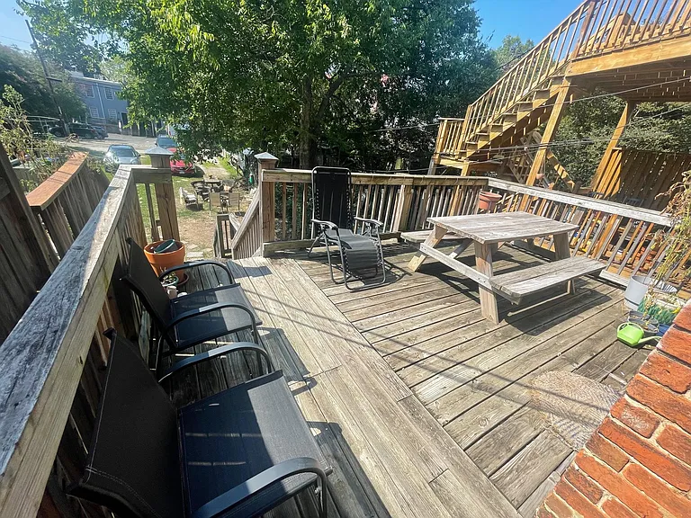 Rear private deck overlooking backyard. Doors to deck from bedroom and kitchen.