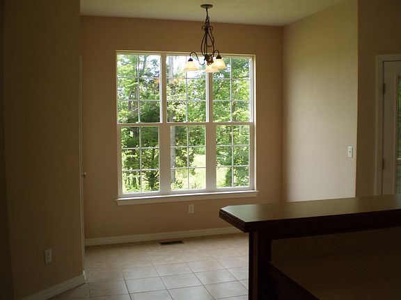 Second eating area in the Kitchen with a beautiful of the wooded yard