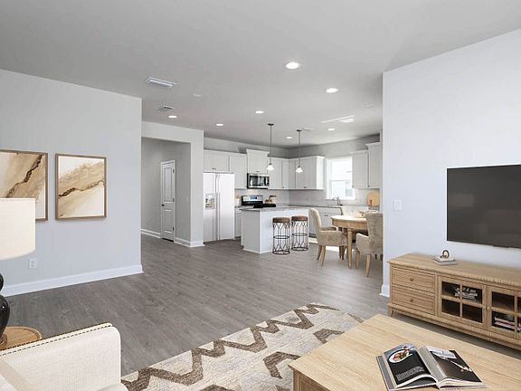 The open floor concept with beautiful wood flooring is the perfect space to gather with friends.