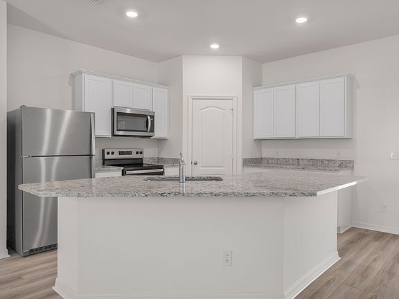 The kitchen has a large island that will be perfect for you and your family to gather around