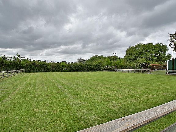 ~141 x111 fenced horse arena. Notice the arena lighting.