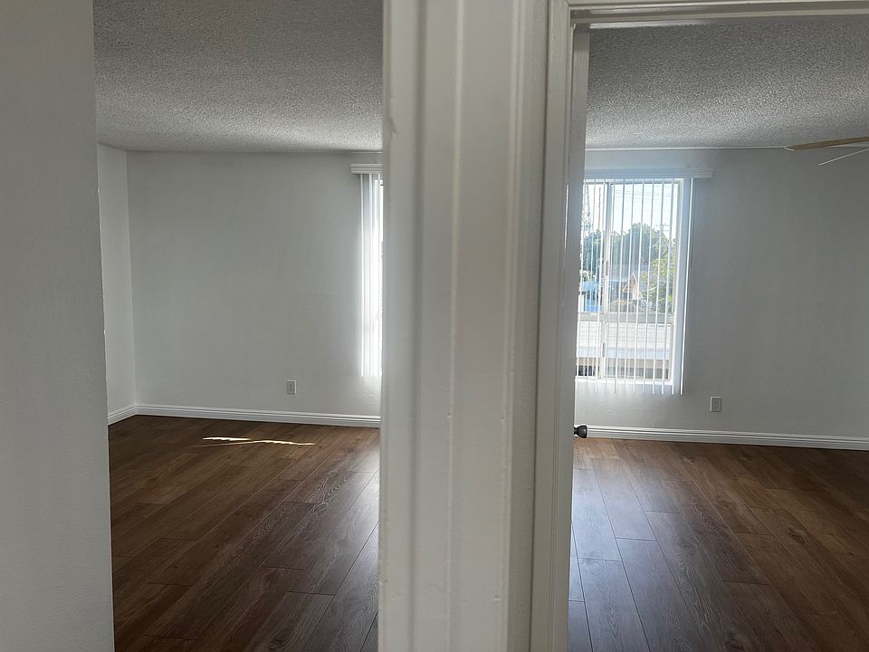 Standing in the hallway looking into both the primary bedroom and the guest bedroom (2x2)