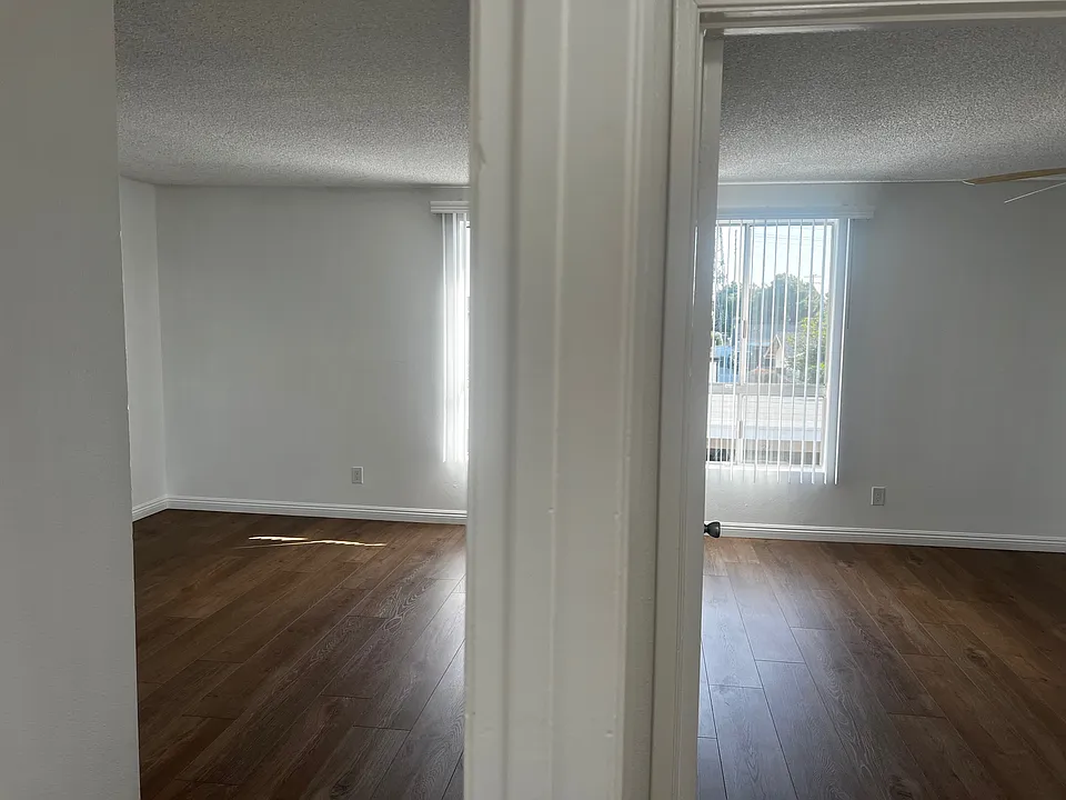 Standing in the hallway looking into both the primary bedroom and the guest bedroom (2x2)