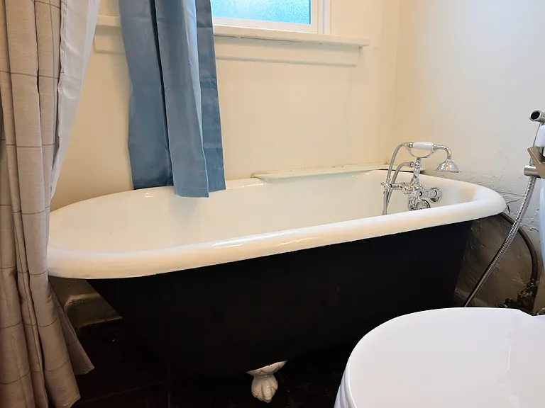 upgraded bathroom with tiled floor, repainted claw foot tub