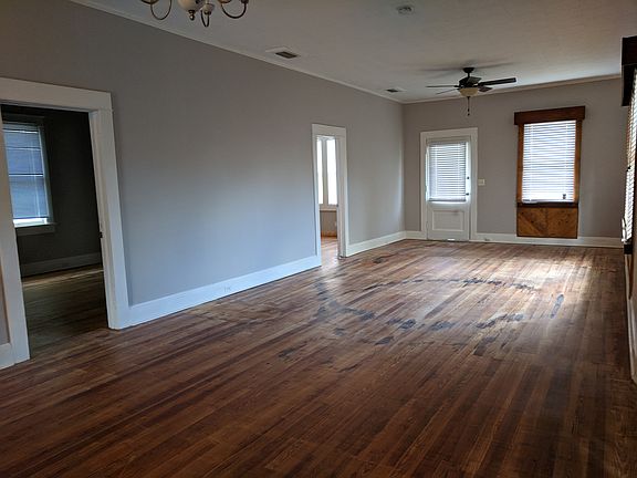 living area view from kitchen showing doors to bedrooms